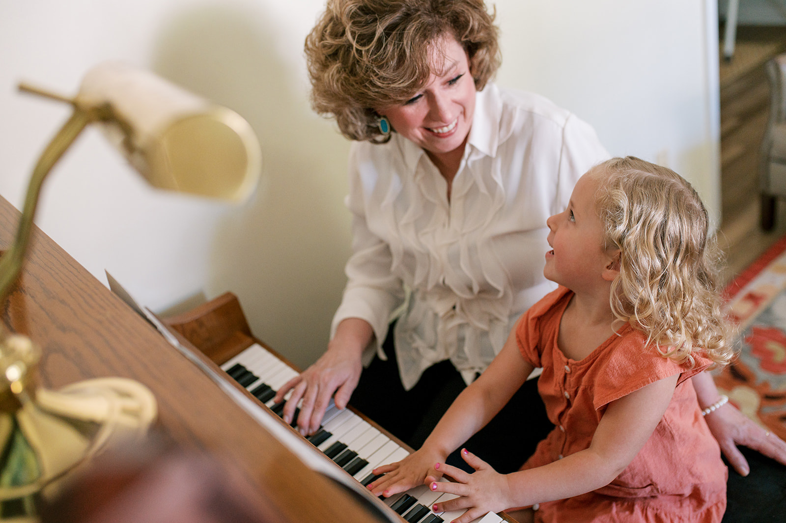 Amy and a young girl playing the piano