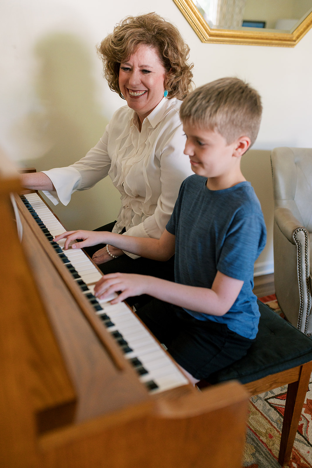 Amy and a young boy playing the piano